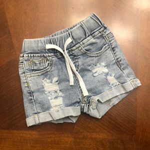 Baby jean shorts, distressed and cuffed.